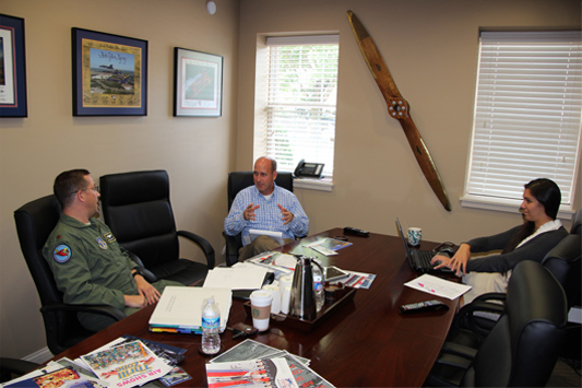 Office discussion around table with Herb Gillen and clients